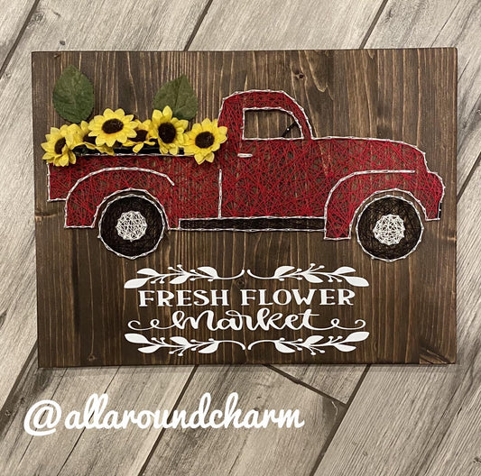 Vintage red truck with sunflowers